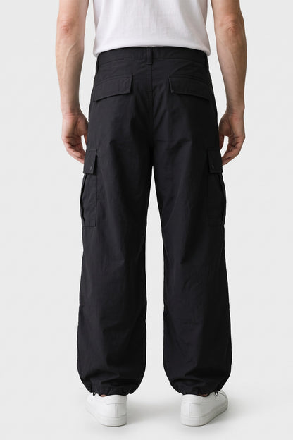 Men's Baggy Cargo Pants | Wide-Leg — Black — back view — on model