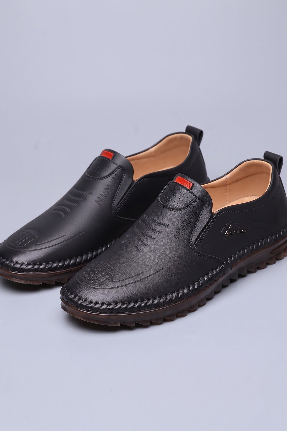 Men's Slip-On Loafers | Moc-Toe Stitching — Black — shoe_main — on model