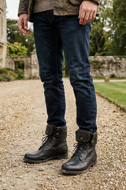Men's black combat boots styled with jeans for fall and winter