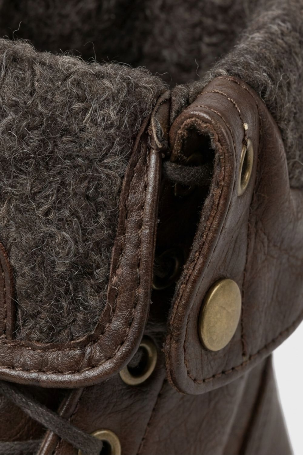 Detail of the brass eyelets and foldover cuff on men's combat boots