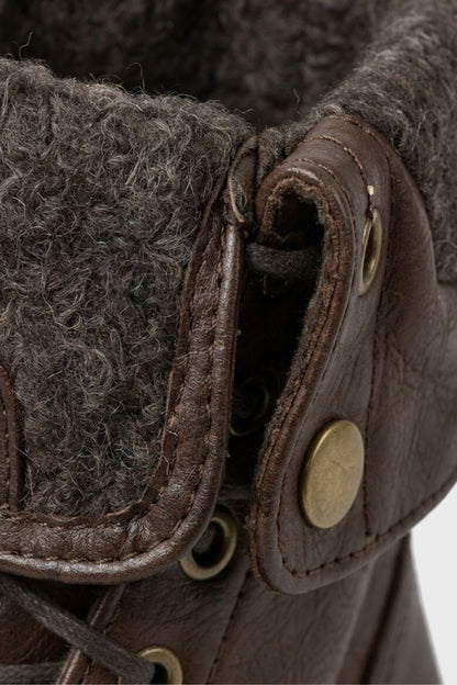 Detail of the brass eyelets and foldover cuff on men's combat boots