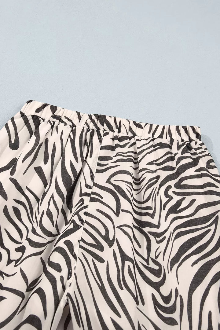 Back elastic waistband of the zebra print pants laid flat