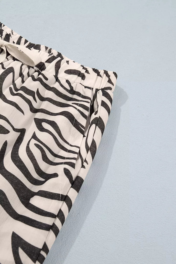 Zebra print pants waist and pocket corner with a small button, laid flat