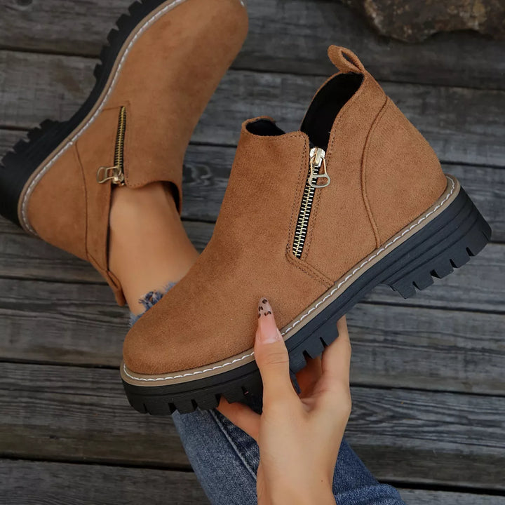 Camel zipper boot held up to show the lug sole and heel