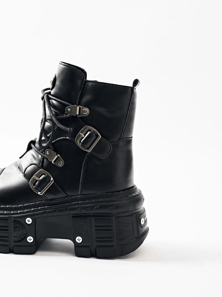 Black chunky platform boot in side view with multiple buckle straps