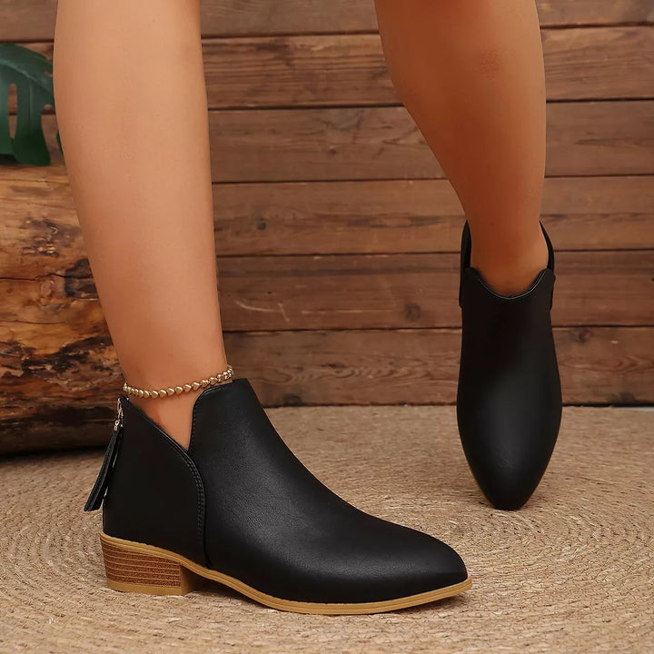 Black low block heel ankle boot, back view showing the zipper pull