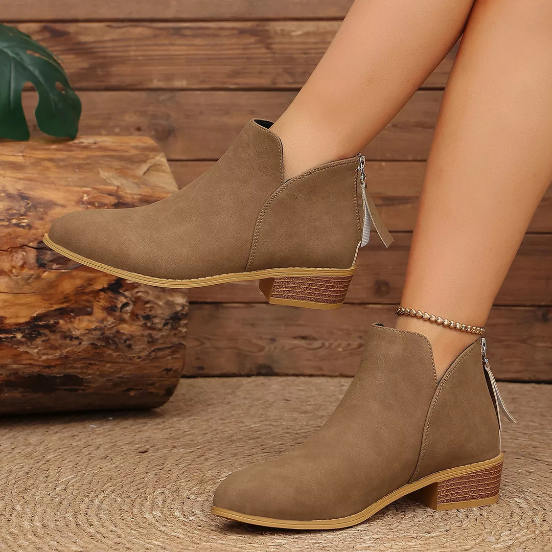 Brown ankle boots with a rear zipper, side view with an ankle bracelet