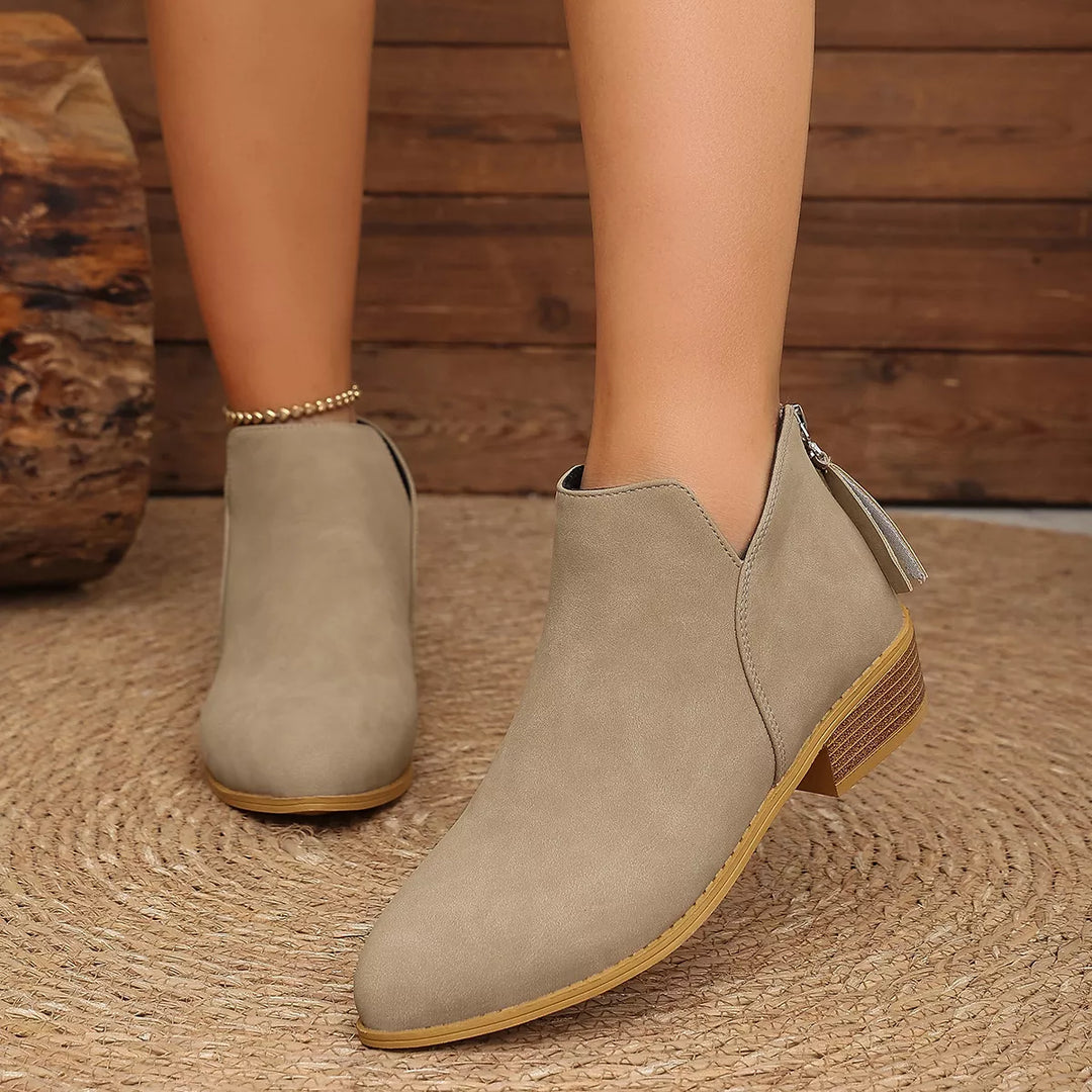 Taupe low heel ankle boots, front three-quarter view with a back tassel zip