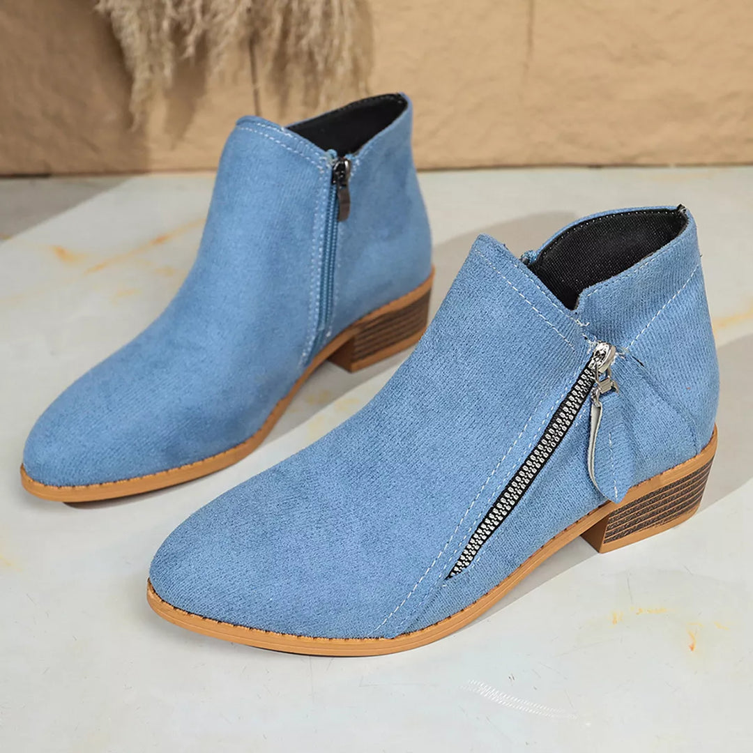 Pair of light blue pointed toe ankle boots from above