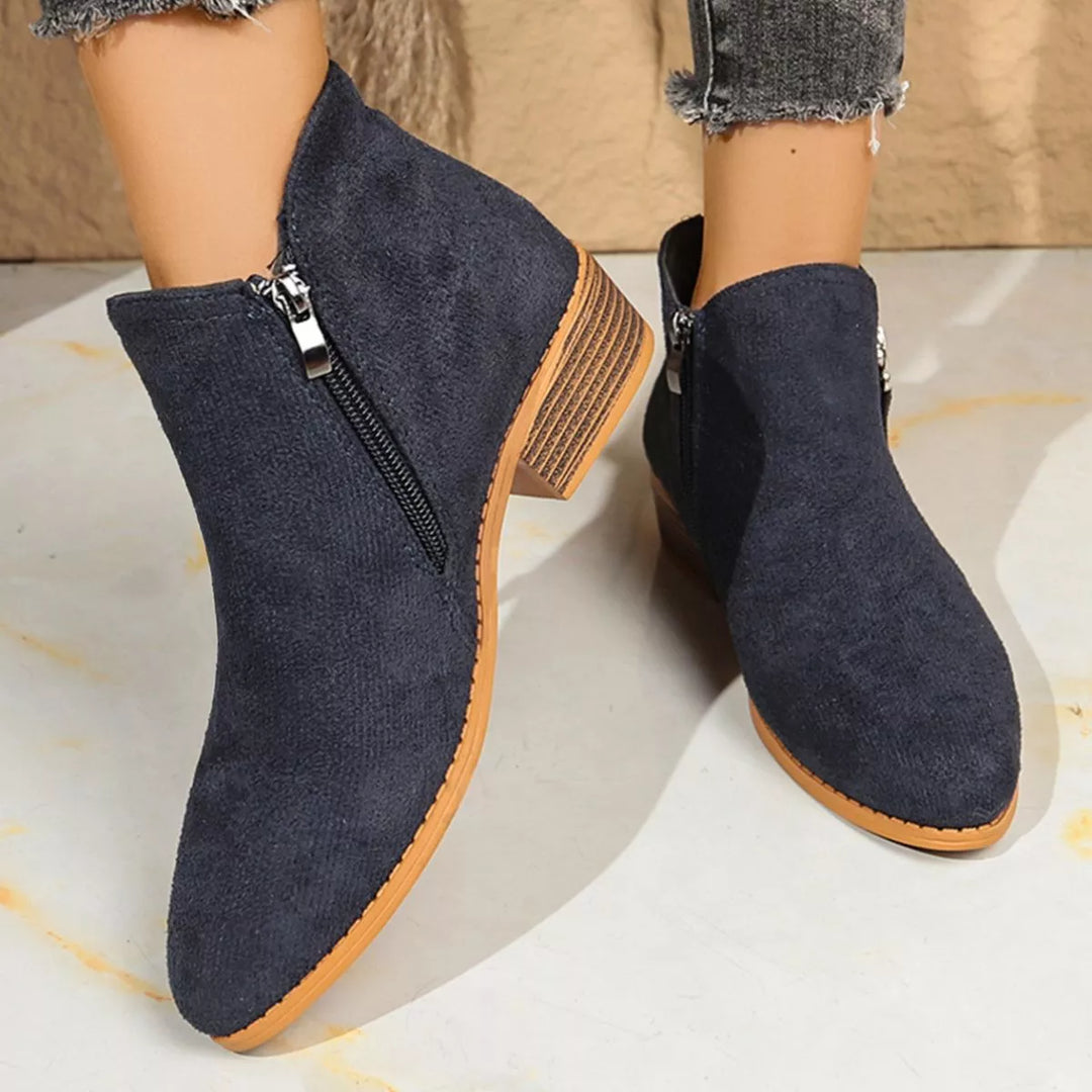 Navy ankle boots with zipper detail and stacked block heel, worn with jeans