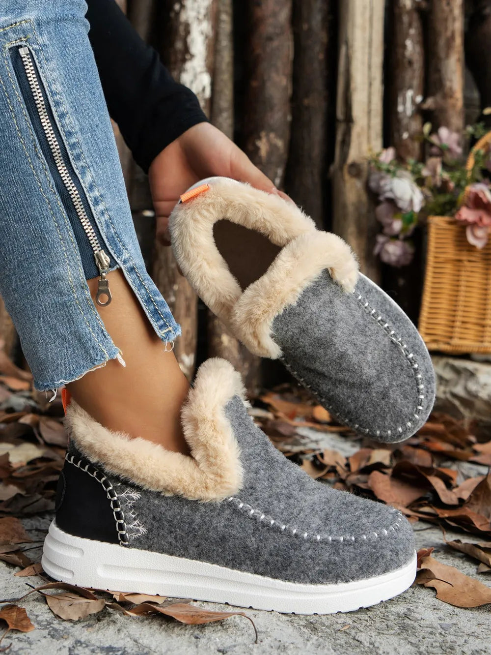 Gray slip on ankle boot with fur-look cuff and white sole, three quarter view