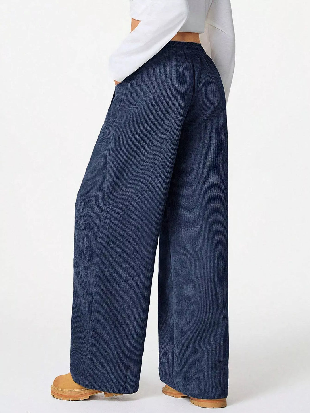 Side view of navy baggy pants with relaxed wide legs