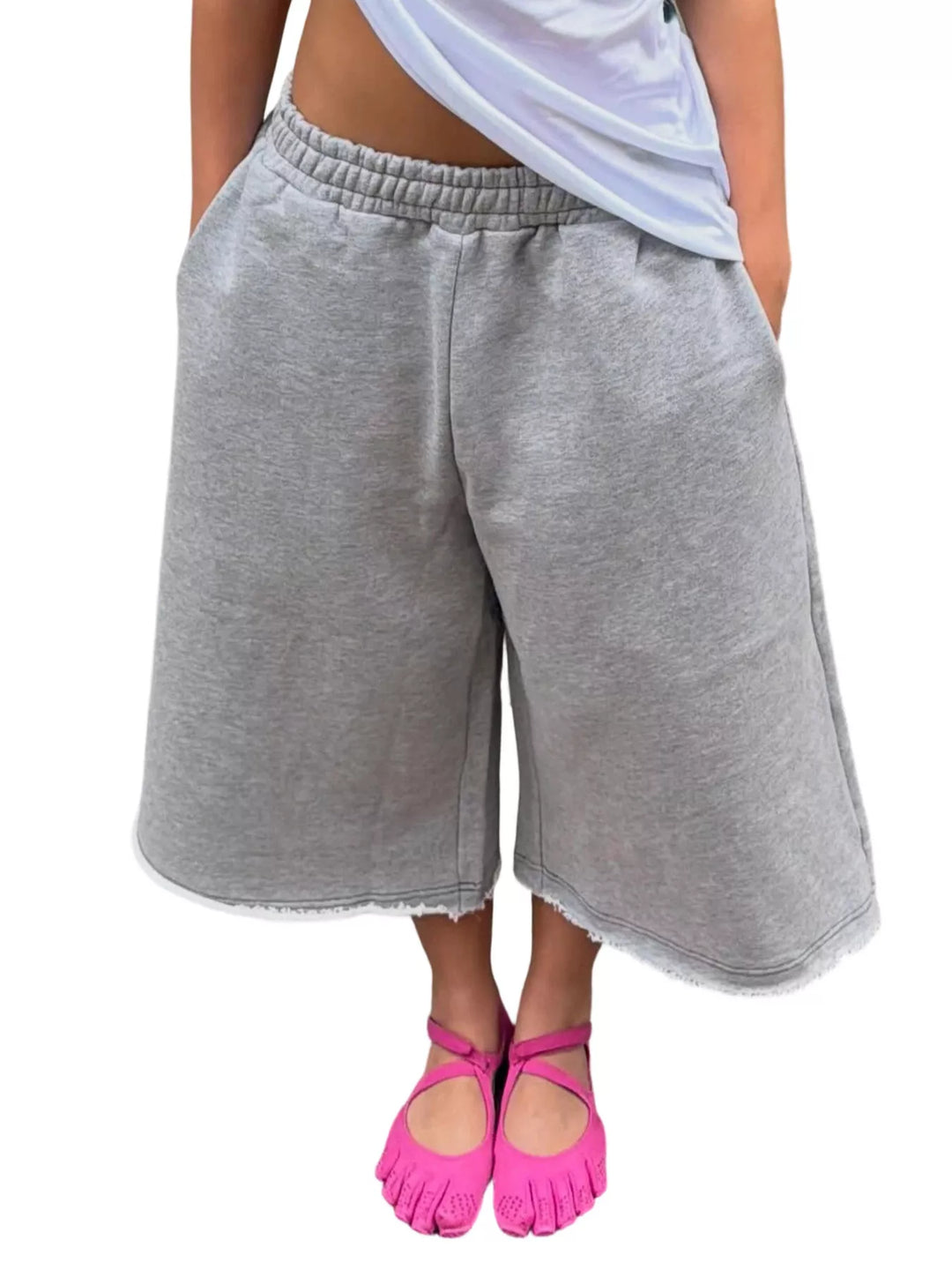 Heather gray baggy shorts with wide legs and frayed hem, front view