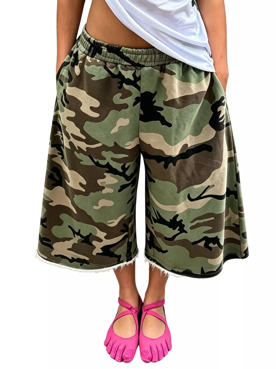 Woodland camo baggy shorts studio view with pink toe shoes and white top
