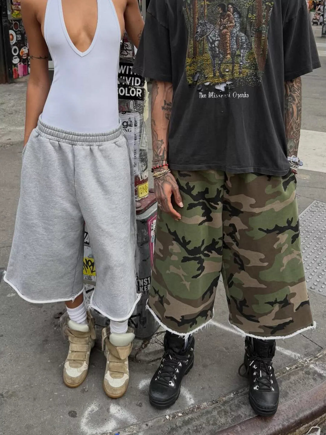 Camo knee length shorts worn with a vest top and black boots, street style