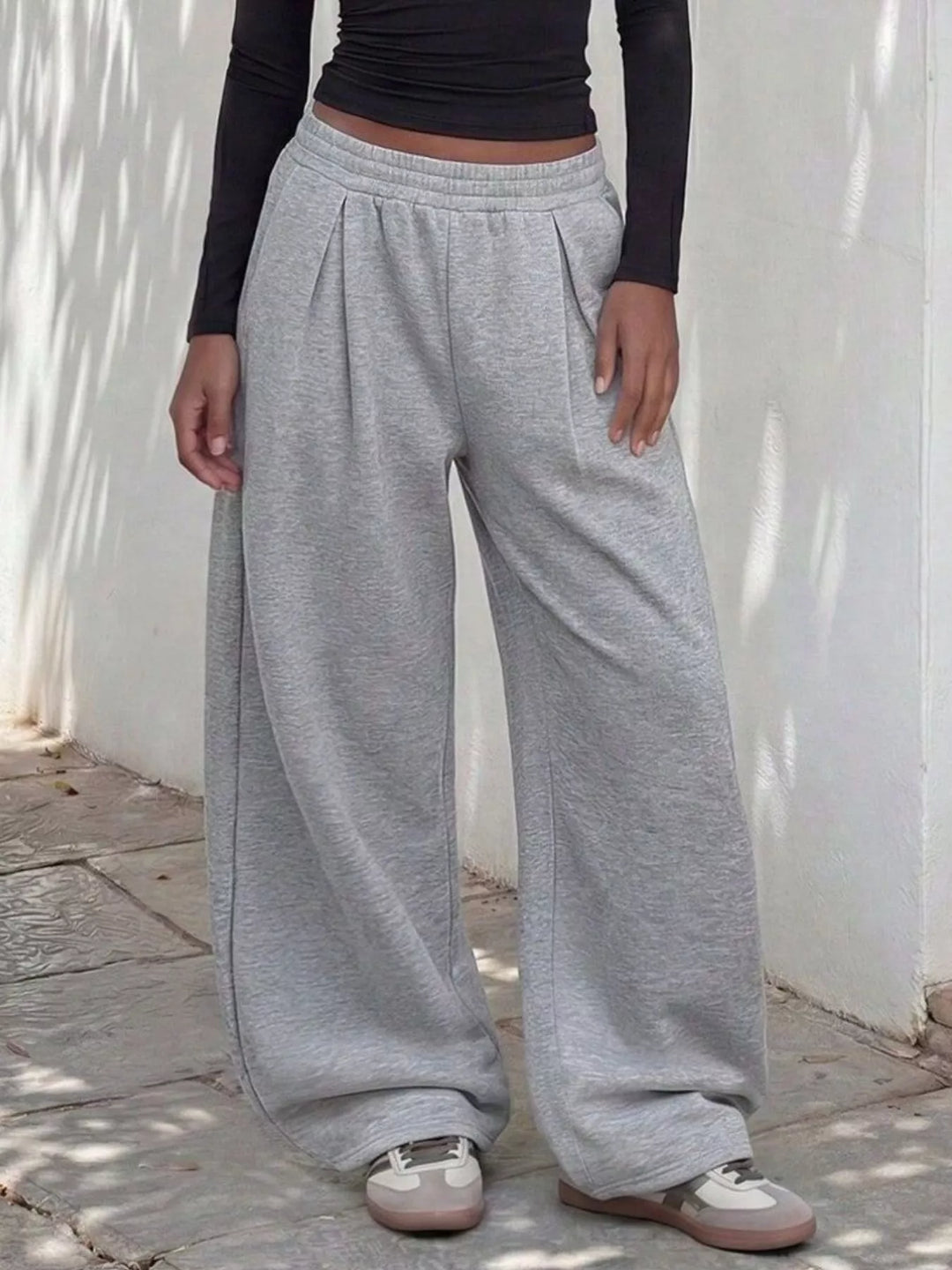 Light gray pleated front sweatpants, straight on view with elastic waist