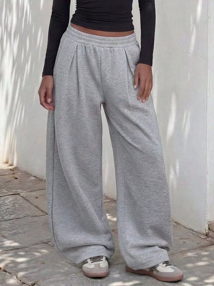 Light gray pleated front sweatpants, straight on view with elastic waist