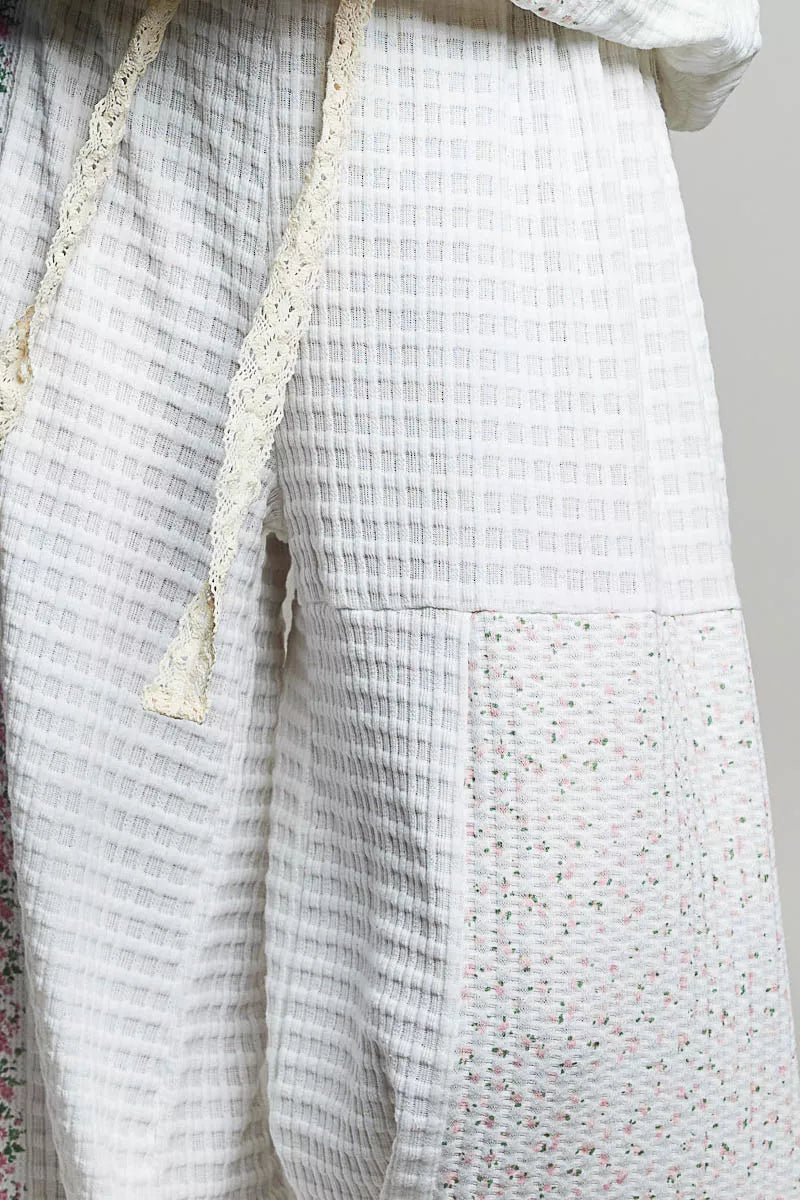 Detail of the ivory waffle knit panel and drawstring on the balloon pants