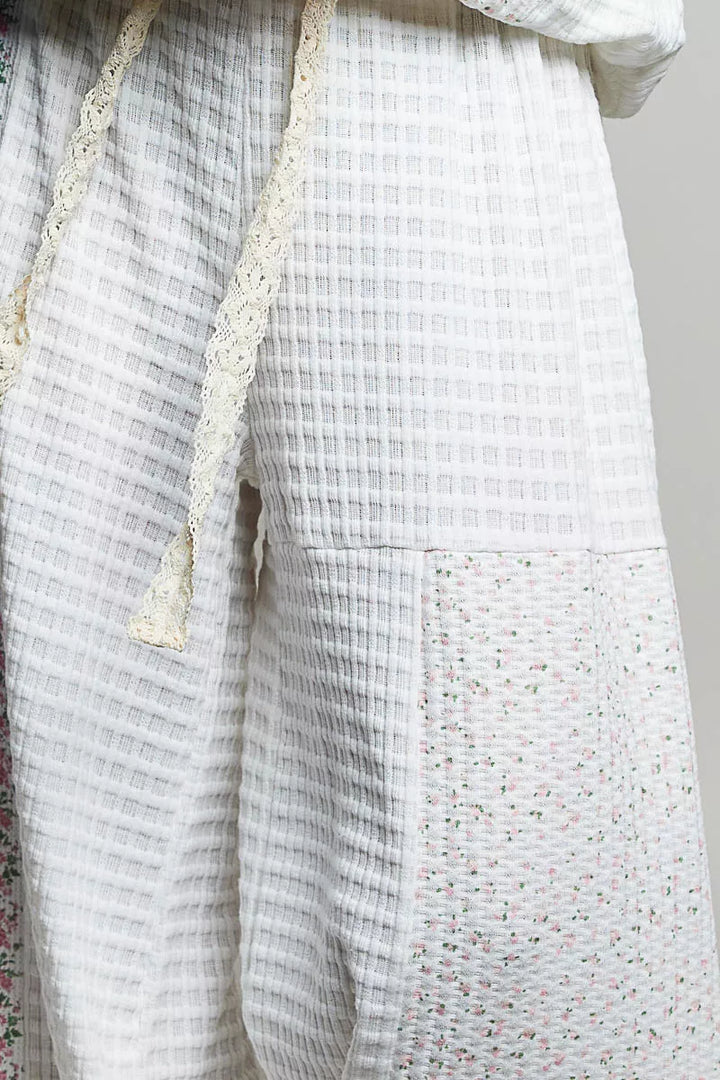 Detail of the ivory waffle knit panel and drawstring on the balloon pants