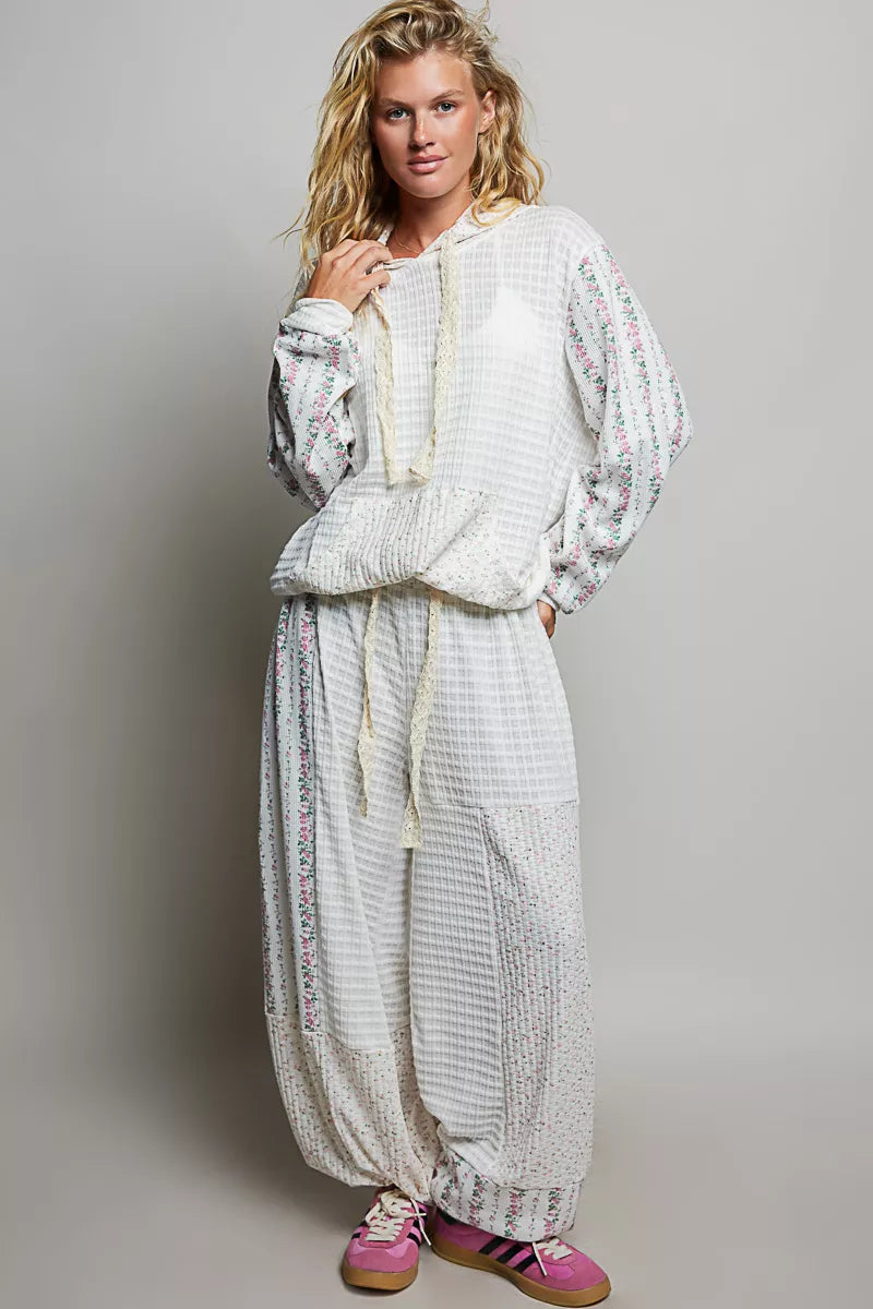 Ivory balloon pants styled with the matching sweatshirt and pink sneakers