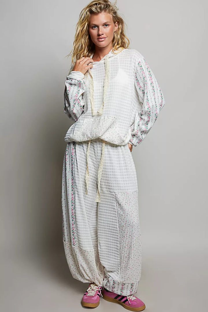 Ivory balloon pants styled with the matching sweatshirt and pink sneakers