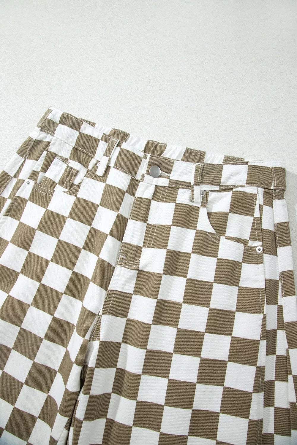 Close-up of the high waisted checkerboard waistband and front pockets