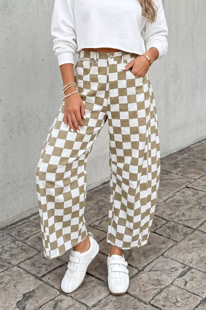 Khaki checkerboard pants styled with a white cropped top and white sneakers
