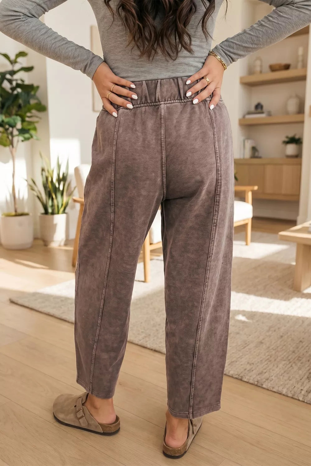 Back view of the mocha washed barrel leg pants with hands on hips