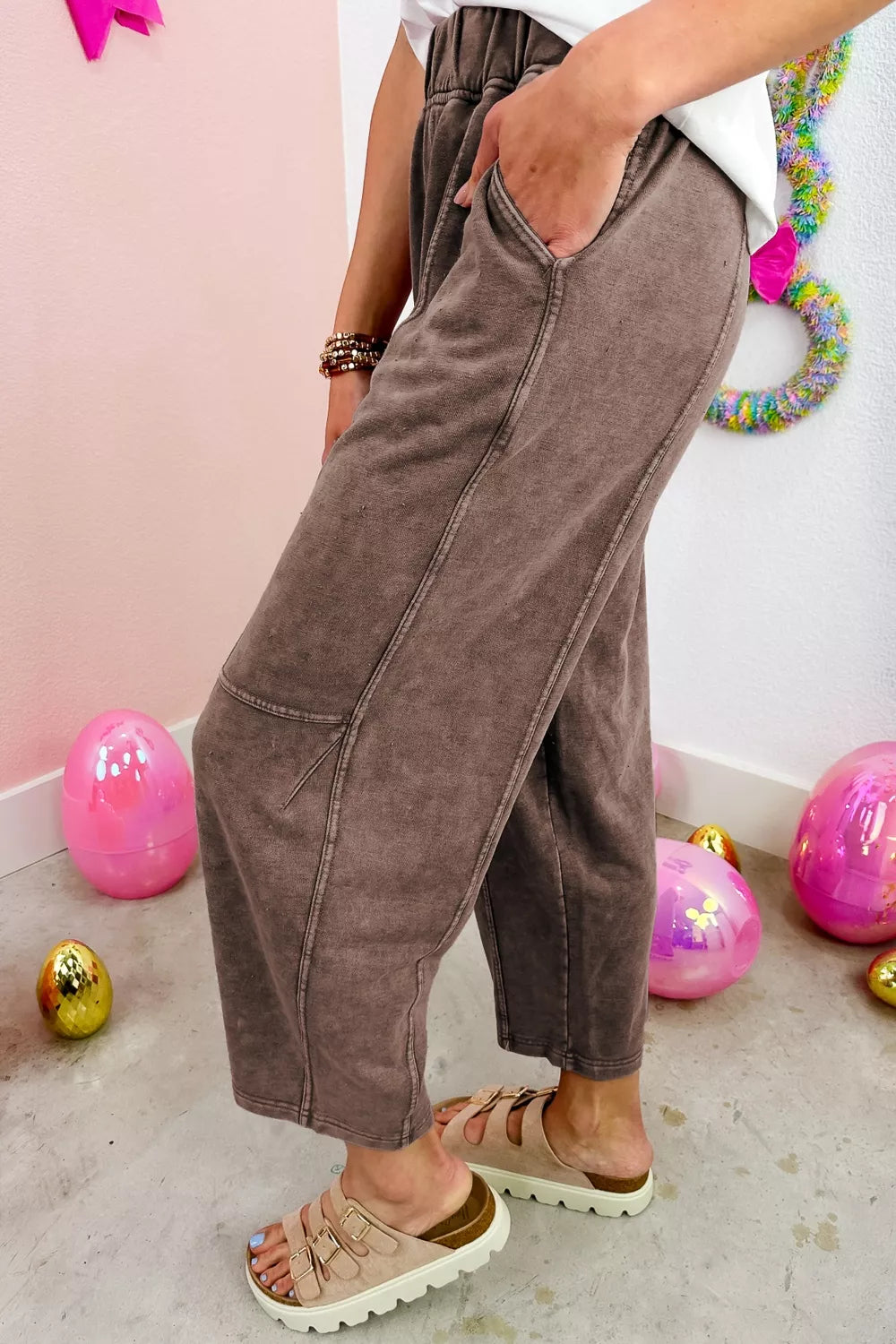 Side view of the mocha barrel leg pants with a visible leg seam