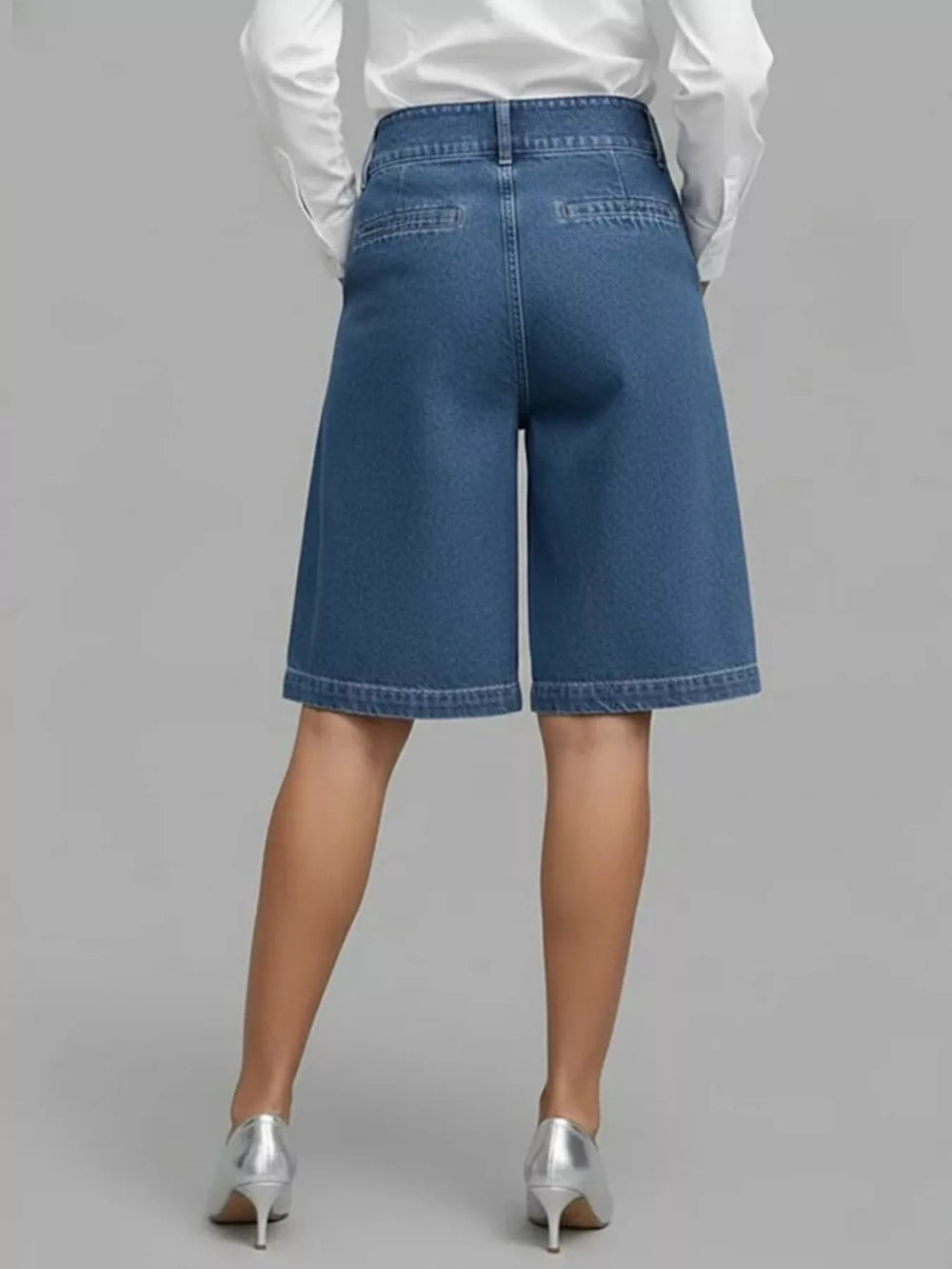 Back view of the dusty blue knee length Bermuda shorts with silver heels