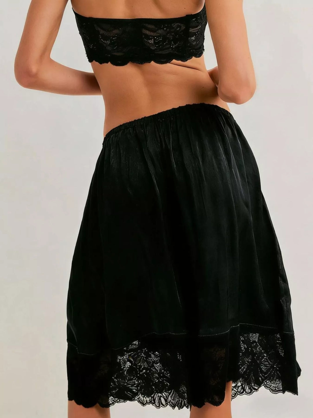 Back view of black Bermuda shorts with lace trim hem