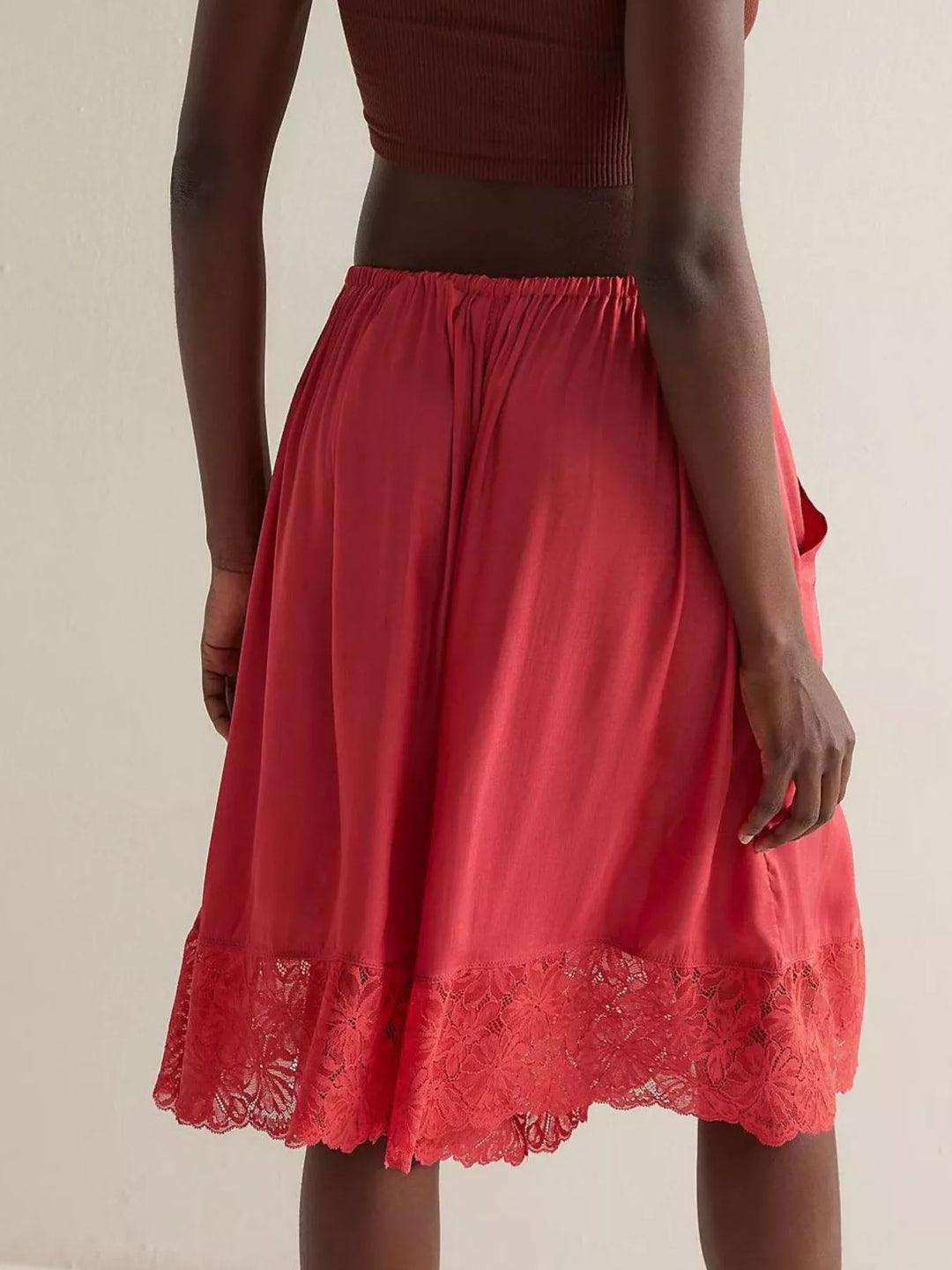 Back view of deep red Bermuda shorts with lace hem