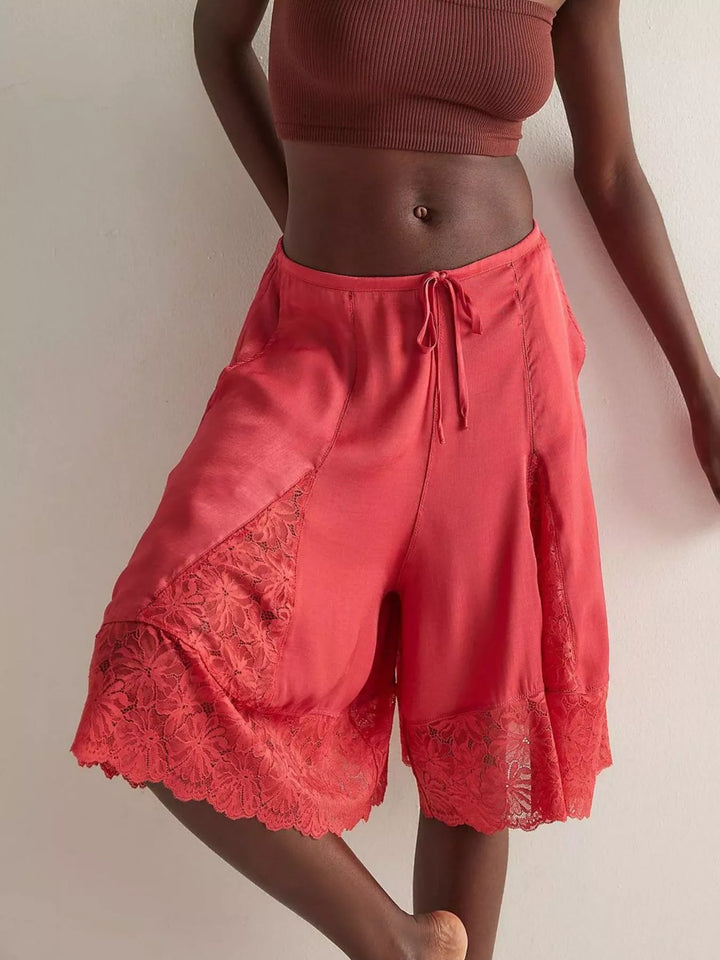 Deep red Bermuda shorts with lace trim hem, front view