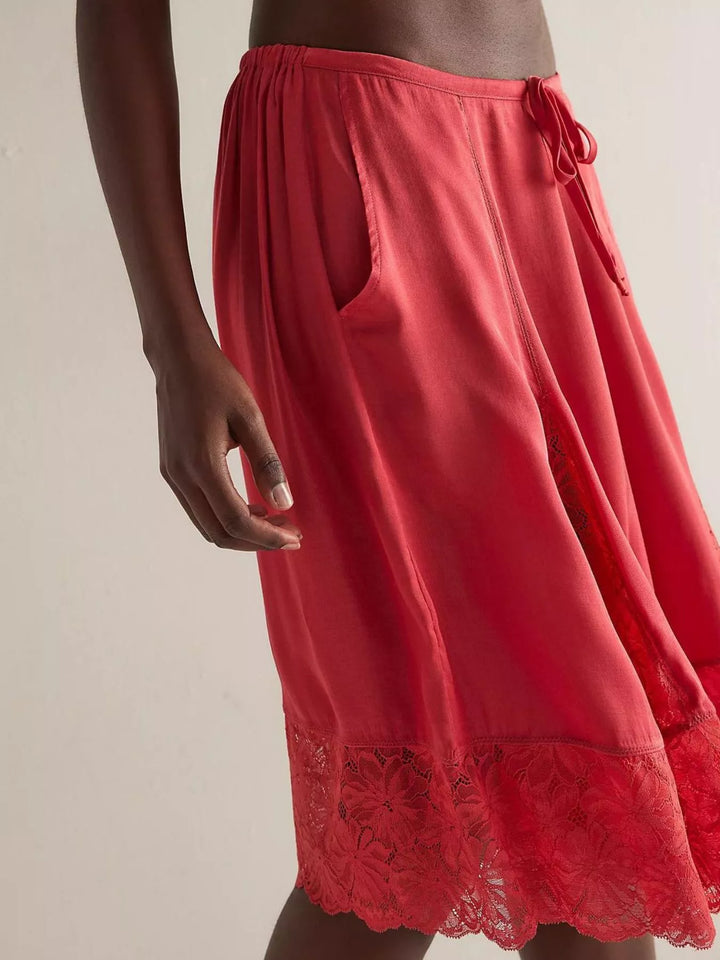 Side view of deep red Bermuda shorts with drawstring waist and pockets