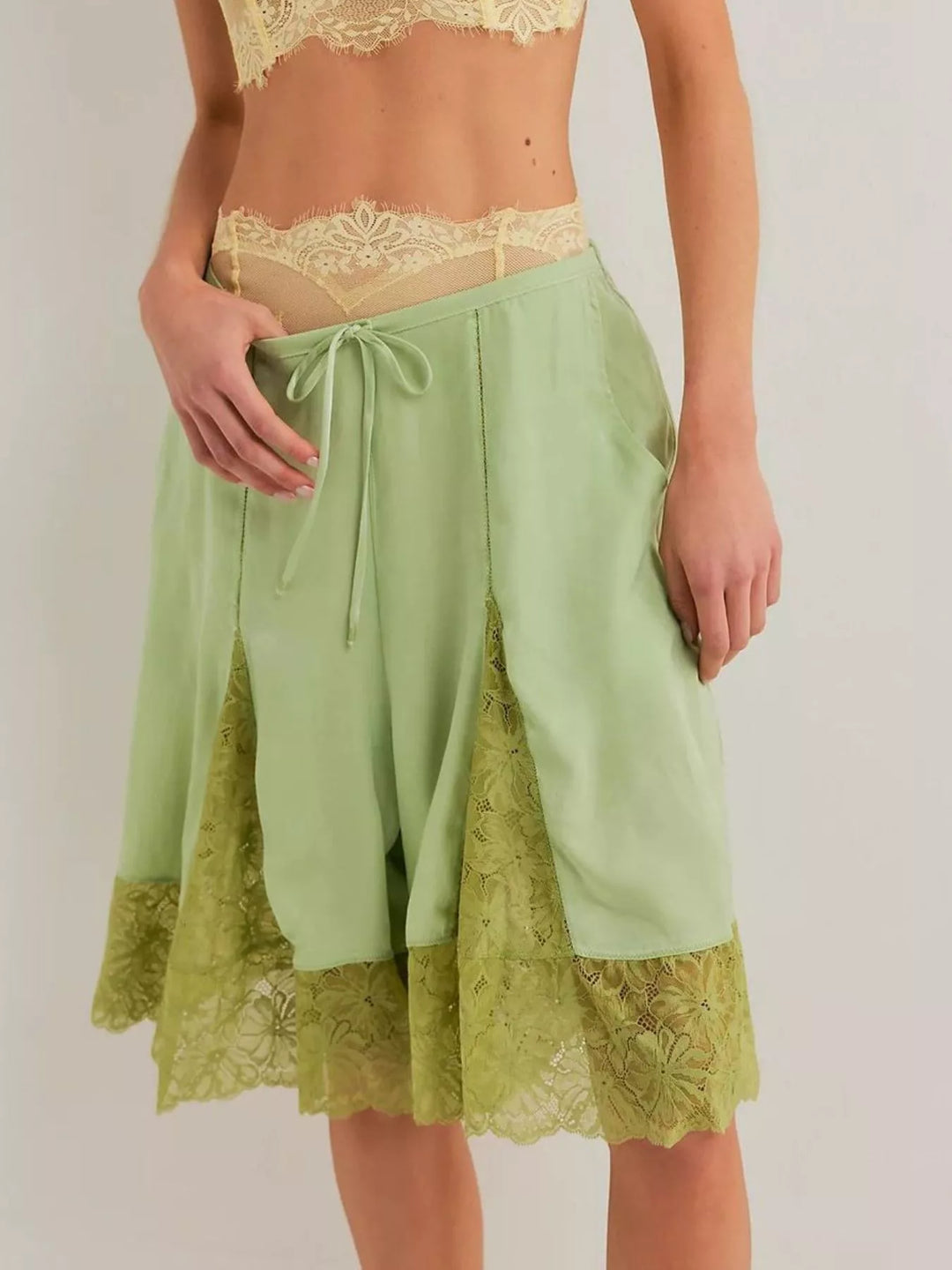 Gum leaf green Bermuda shorts with lace trim hem, front view