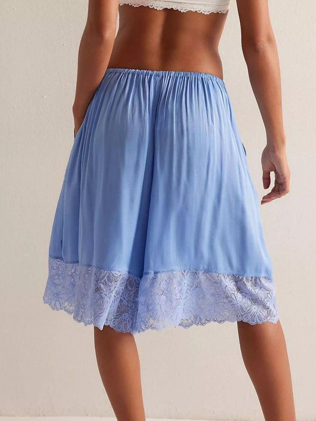 Back view of light blue Bermuda shorts with lavender lace hem