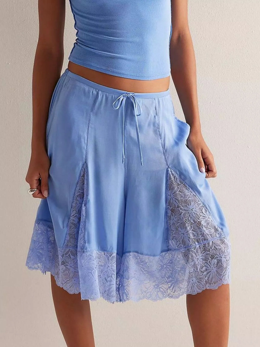 Light blue lace trim Bermuda shorts styled with a blue tank top