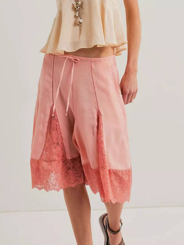Front view of pink Bermuda shorts with drawstring waist and lace trim
