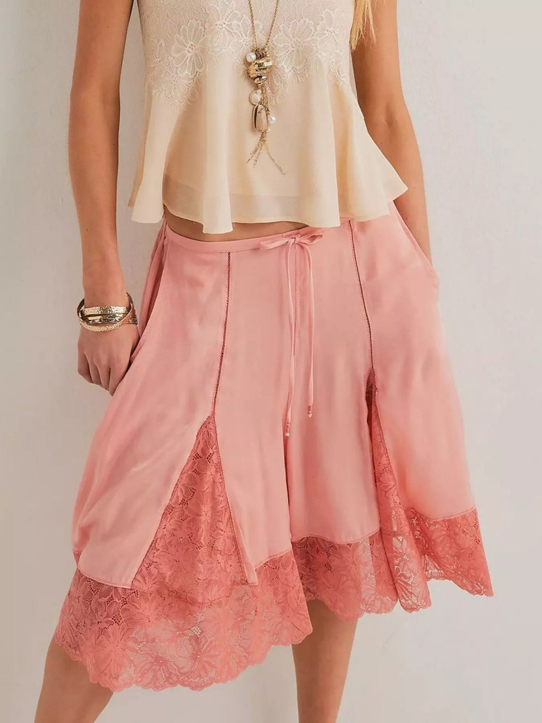 Pink lace trim Bermuda shorts worn with a beige camisole