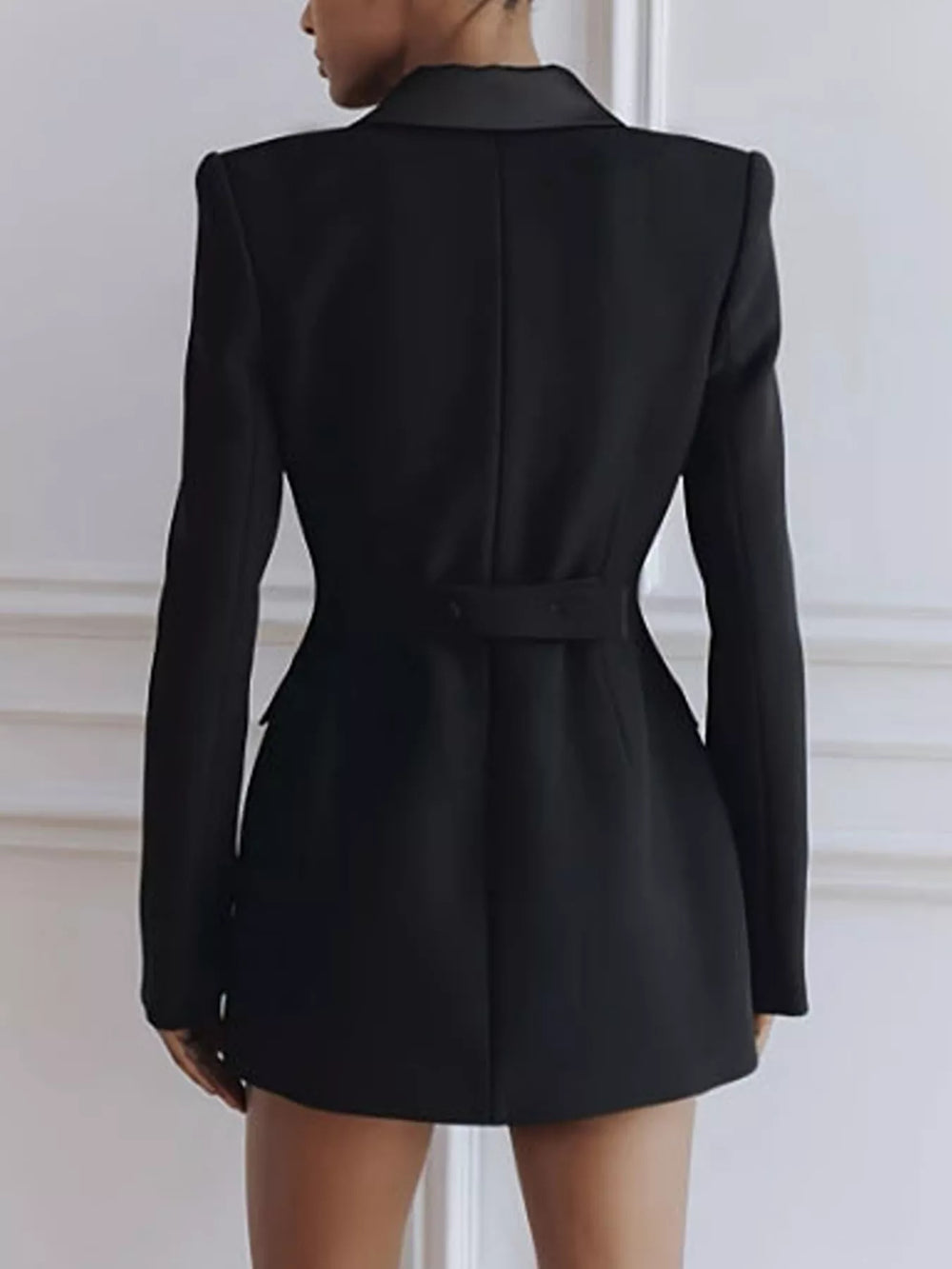 Back view of the black blazer dress with a belted waist tab