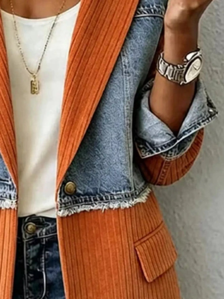 Detail of rust orange blazer button, frayed denim seam and flap pocket