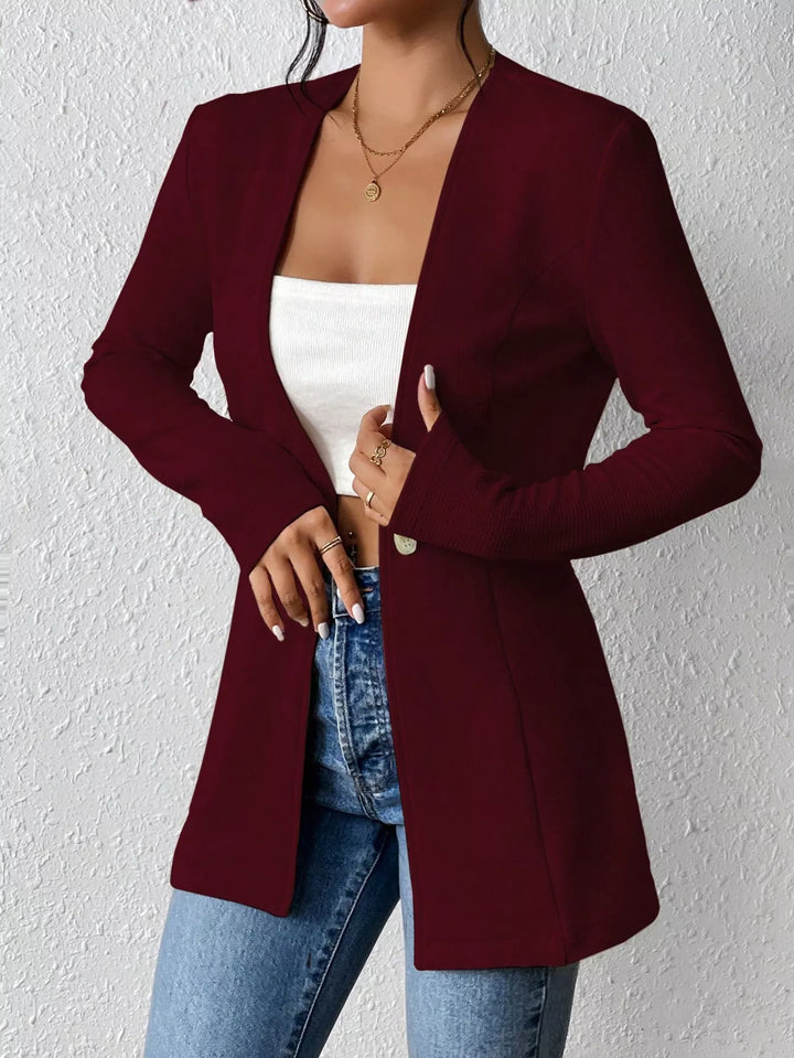 Burgundy one button blazer on-model with a hand at the lapel