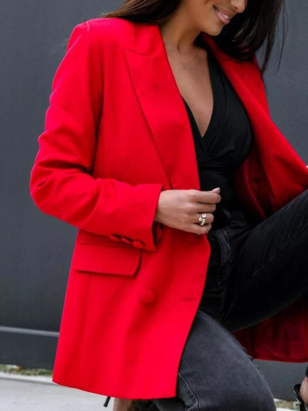 Red notch lapel blazer with hand at the lapel, lined interior visible