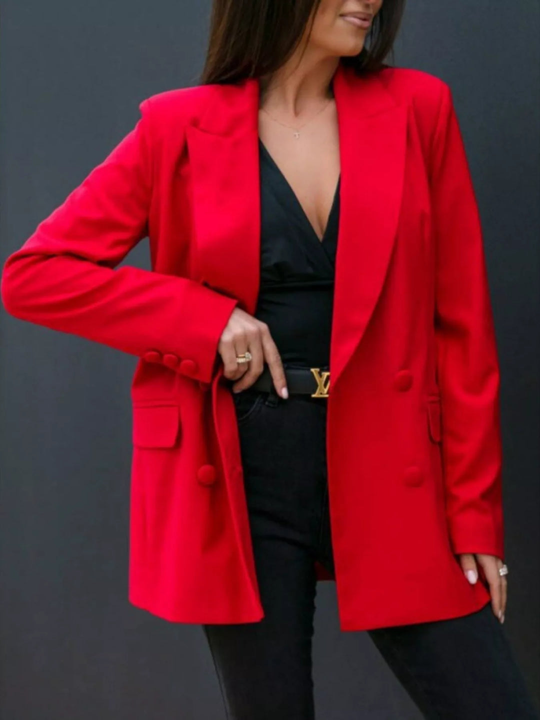 Red oversized double breasted blazer worn open over a black top and pants