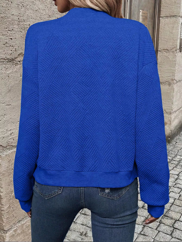 Back view of the royal blue cropped bomber jacket