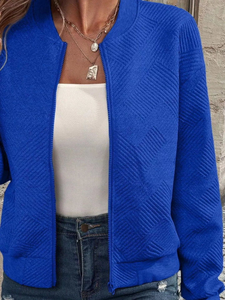 Close-up of the royal blue quilted diamond bomber jacket texture