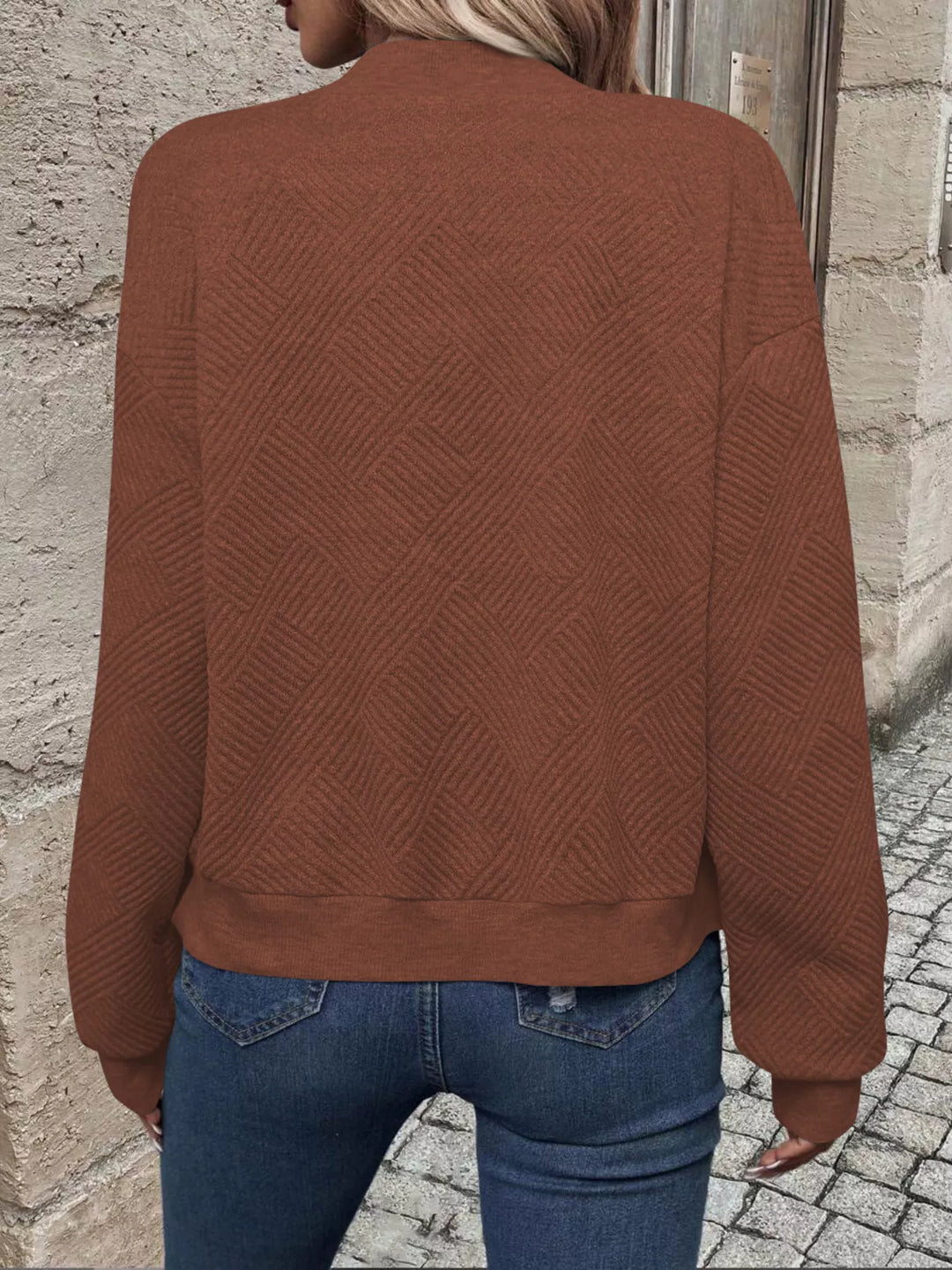 Back view of the rust brown quilted bomber jacket