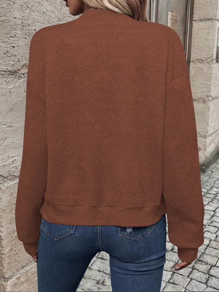 Back view of the rust brown quilted bomber jacket