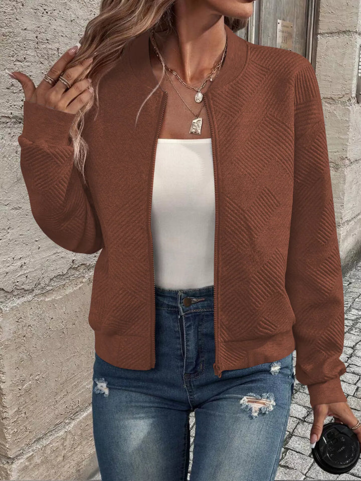 Rust brown cropped bomber jacket worn open over a white top