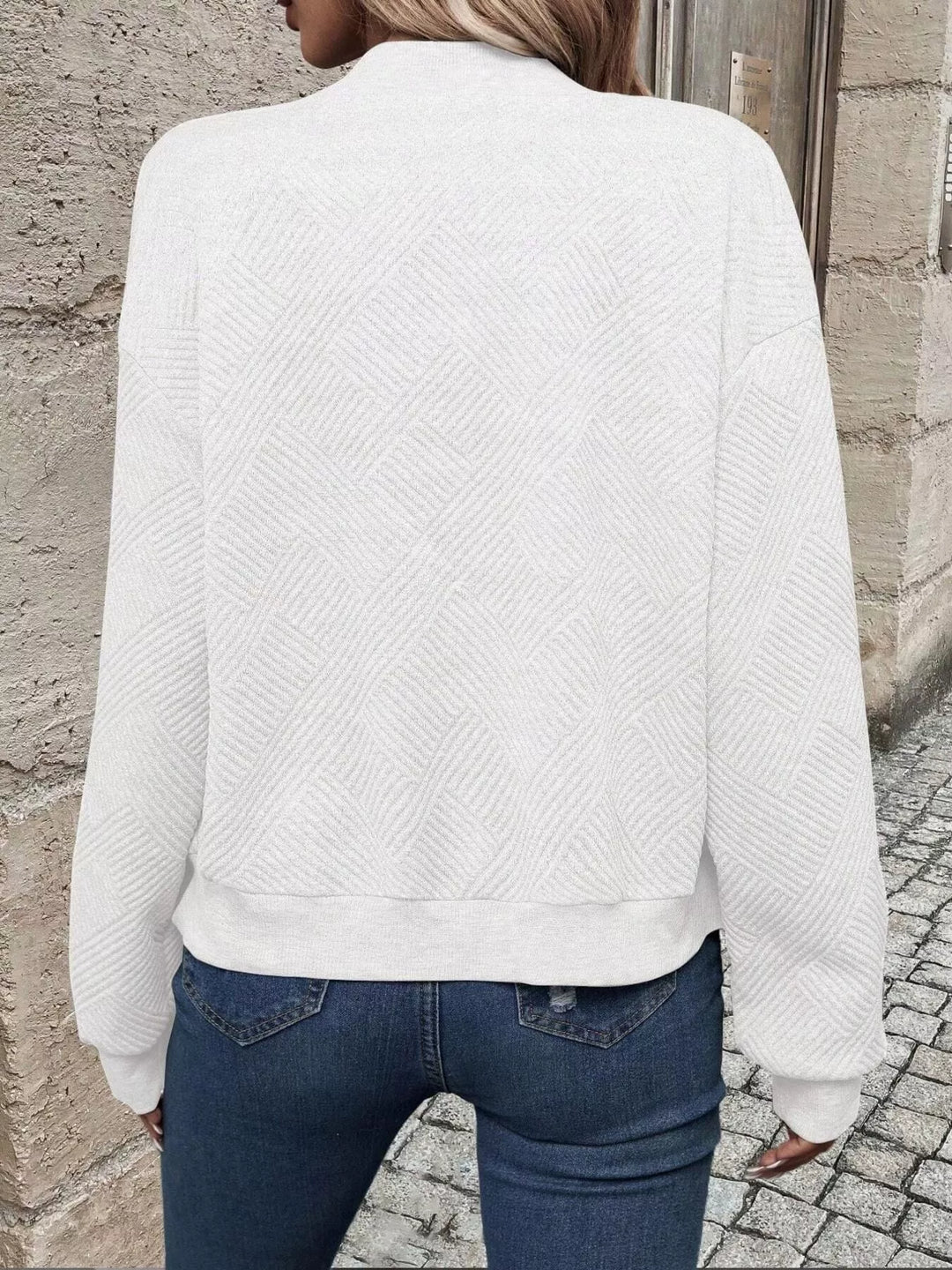 Back view of the white quilted diamond bomber jacket